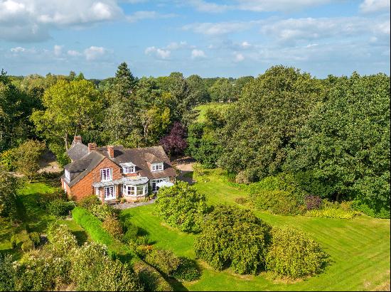 A beautiful historic house occupying approximately 4.65 acres with outbuildings, a tennis 