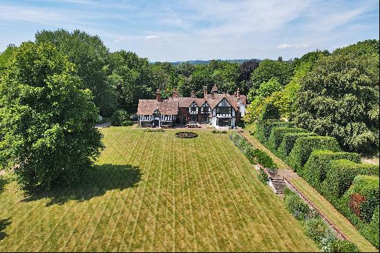 In an elevated rural position, surrounded by formal gardens and parkland, a significant Gr