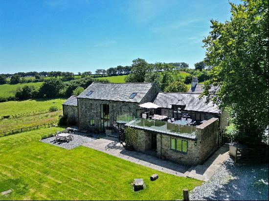 A beautifully presented barn conversion in 1.87 acres with views over unspoilt Dartmoor co