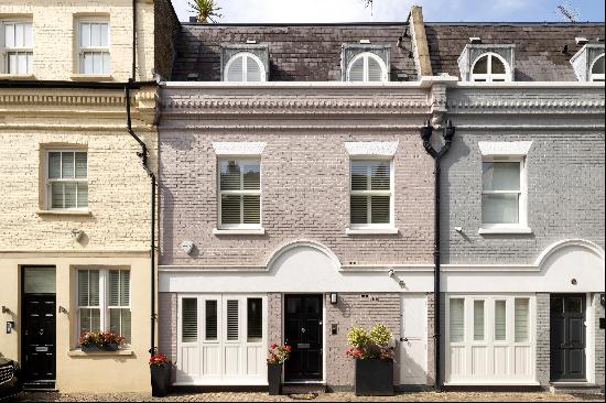 An exceptional three bedroom mews house with a lift and decked roof terrace for sale on a 