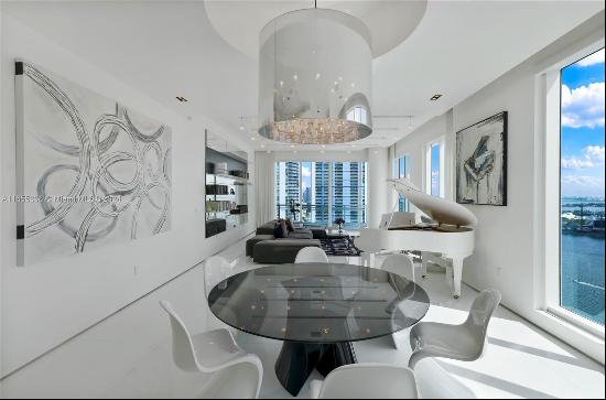 A stunning, high-floor, custom-designed 4 bedroom + office home on Brickell Key, with high