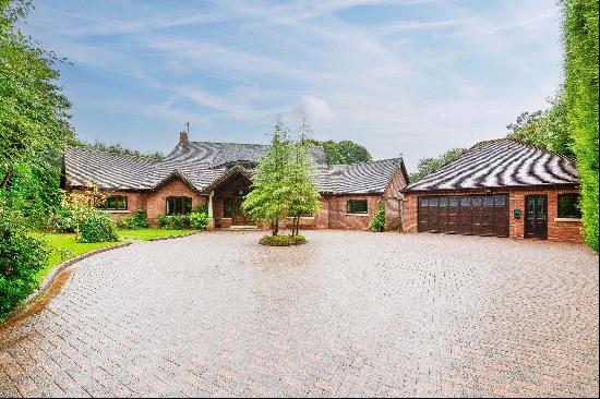 An architect designed family home set in 0.5 acres of private garden with a garage and sep