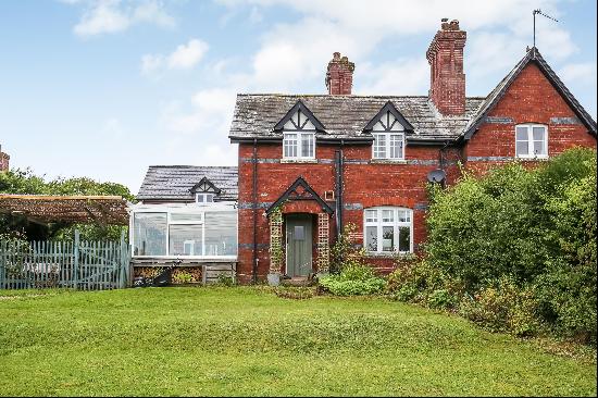 A Victorian semi-detached cottage with a modern extension, set in an elevated position on 