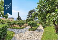 Behind Villa d'Este, a prestigious, finely restored period estate with a park and a lake-v