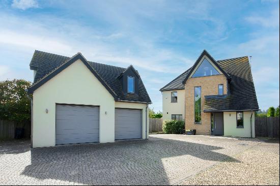 A stunning contemporary village home set within a private gated development with great vie