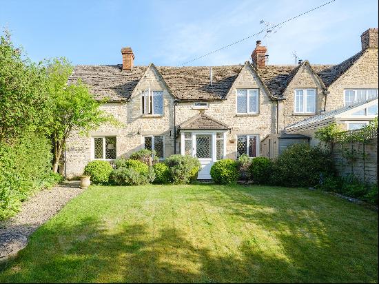 A charming three bedroom semi detached Cotswold stone cottage with private gardens tucked 