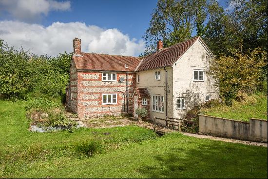 An enchanting, unlisted converted corn mill with 5.64 acres set in a blissfully tranquil a