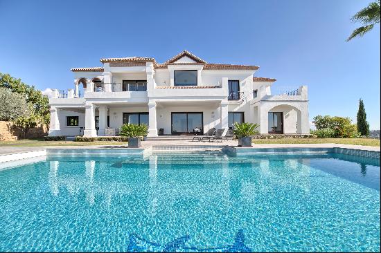 An elegant hilltop villa with incredible golf, sea and mountain views.