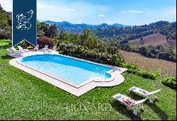 Historic renovated country estate with a swimming pool and olive grove for sale in Urbino