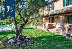 Historic renovated country estate with a swimming pool and olive grove for sale in Urbino