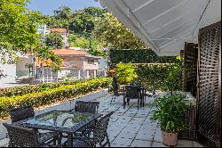 House with views of greenery, the ocean, and Dois Irmaos in a gated community wi