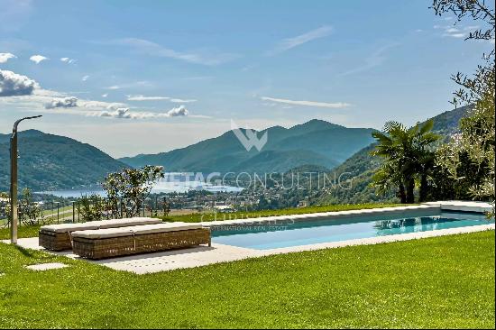 Stunning villa with expansive swimming pool & Lake Lugano views, available for sale in Lu