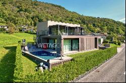 Modern designer villa with outdoor pool for sale in Lugano-Sessa, set amidst lush greenery