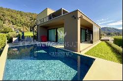 Modern designer villa with outdoor pool for sale in Lugano-Sessa, set amidst lush greenery