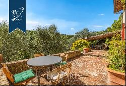 Luxury villa with a huge garden overlooking the lake for sale on Tuscan hills