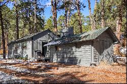 Two turn of the century charming cabins nestled in towering pines