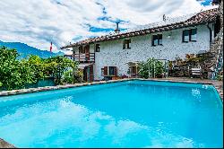 Ticino house with 20'000 sqm of land, swimming pool, and rustic house