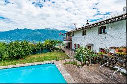 Ticino house with 20'000 sqm of land, swimming pool, and rustic house