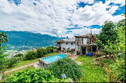 Ticino house with 20'000 sqm of land, swimming pool, and rustic house