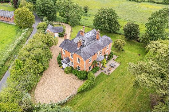 An impressive former vicarage with land, former coach house and wonderful rural views, wel