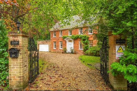 An attractive family home set in just over 0.6 of an acre within a wooded and secluded set