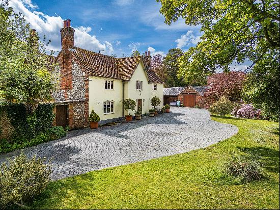 A handsome farmhouse with well-established walled gardens, plenty of parking in the heart 