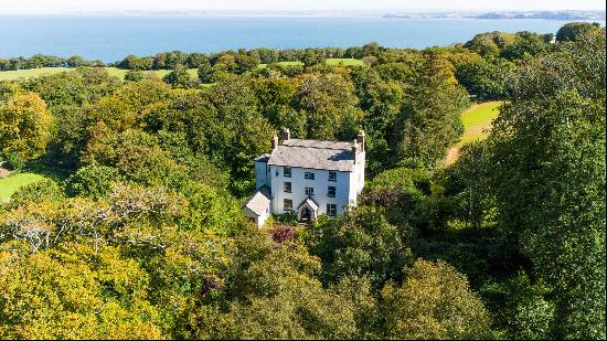 An imposing former rectory set in wooded grounds amidst beautiful surroundings half a mile