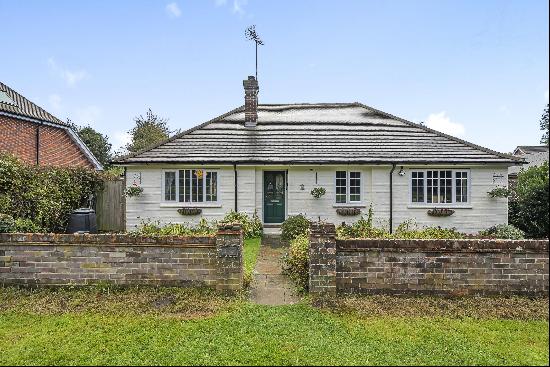 A charming bungalow situated in a popular village overlooking common land.