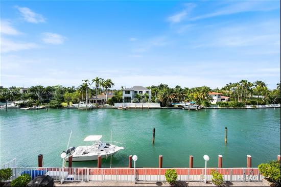 Bay Harbor waterfront residence in boutique bldg w/unique opportunity to dock your boat in