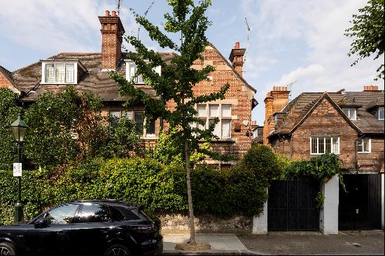 A wide semi-detached south-facing villa arranged over three principal floors with a unique