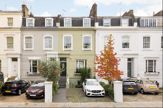 An impressive five bedroom stucco fronted freehold townhouse with off street parking, a la