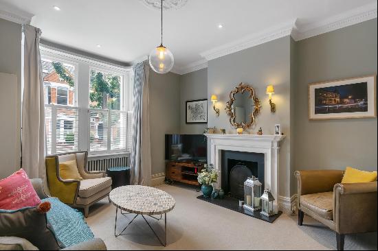 A stunning Victorian five bedroom family home with elegant period features, located close 