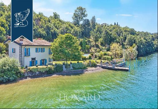 A newly renovated estate with a panoramic swimming pool, private beach, jetty and dock for