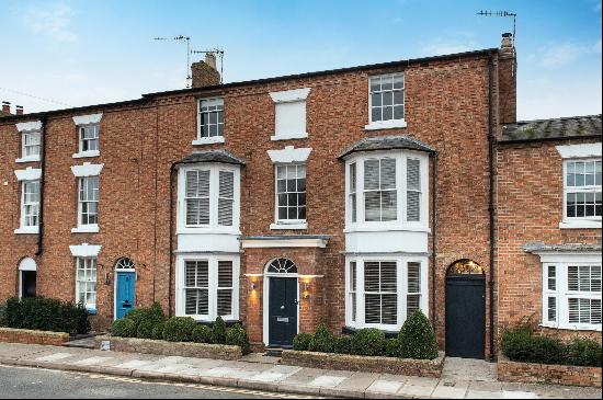 A handsome double-fronted townhouse with an unexpectedly large garden, occupying a central