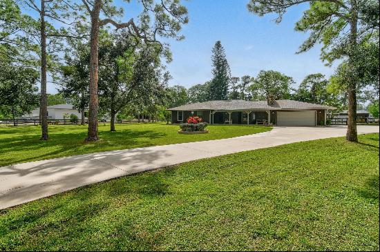 Welcome to Jupiter Farms, where country charm meets modern convenience. This one is locate