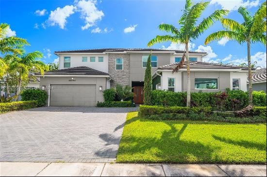 Welcome to one of the finest designer homes in Miramar! This stunning 5-bedroom, 5-bathroo