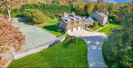 Estate living in the village of Quogue. Behind the gates you will find this 8-bedroom, 7 1