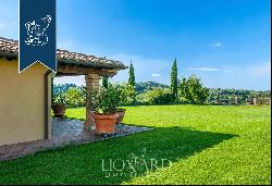 Elegant villa with outbuilding, garden and olive grove for sale on the hills between Pisa 