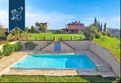 Elegant villa with outbuilding, garden and olive grove for sale on the hills between Pisa 