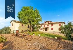 Charming farmstead with agritourism resort for sale on the Tuscan hills