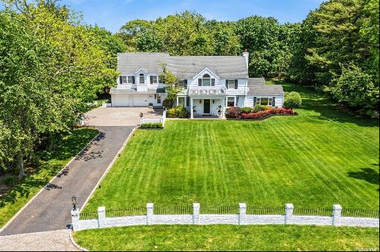 Welcome to this exquisite 5-bedroom, 4.5-bath Colonial home, nestled on a sprawling acre o