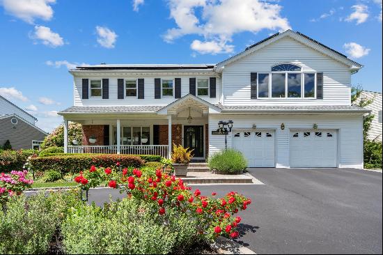 A charming front porch welcomes you to a beautiful 5-bedroom home situated on a fully land