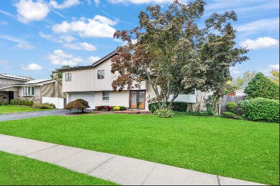 This Spacious 4-Bedroom, 3.5-Bath Split-Level Home In The Jericho School District Boasts M