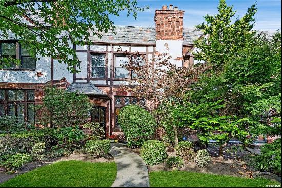 Welcome to 90-07 68th Avenue, a stunning Tudor-style residence crafted by the renowned Wol