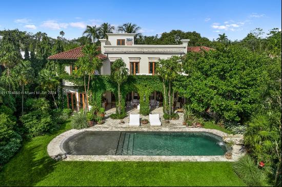 Welcome to this stunning three-story mansion in Coconut Grove's Hughes Cove, where luxury 