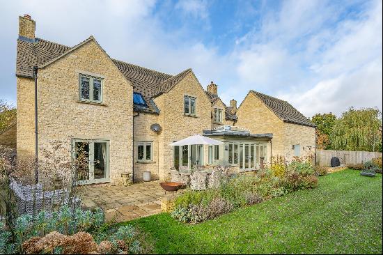 An immaculate detached Cotswold stone family house in an idyllic edge of village setting.