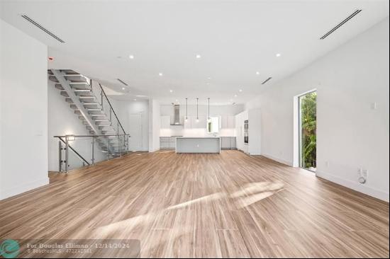 This never-lived-in corner unit townhome offers unparalleled luxury with a private elevato