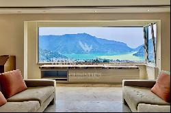 Elegant triplex-apartment for sale in Porza, with lake view, private garden, swimming poo