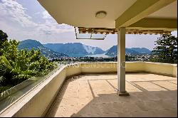 Elegant triplex-apartment for sale in Porza, with lake view, private garden, swimming poo