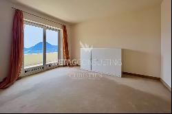 Elegant triplex-apartment for sale in Porza, with lake view, private garden, swimming poo